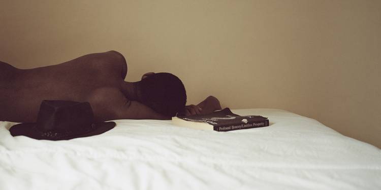 A contemplative picture of a man lying on his father's bed