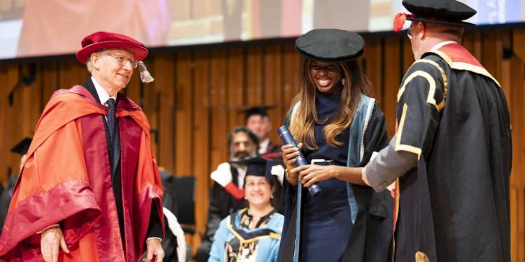 Honorary doctorates June Sarpong and Misan Harriman on stage at graduation