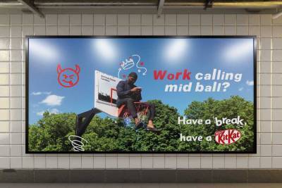 Billboard, a man sitting in a basketball hoop, looking at his phone. Text reads, work calling mid ball? Have a break, have a KitKat